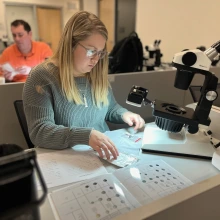 Student studying pearls gemological tools. 